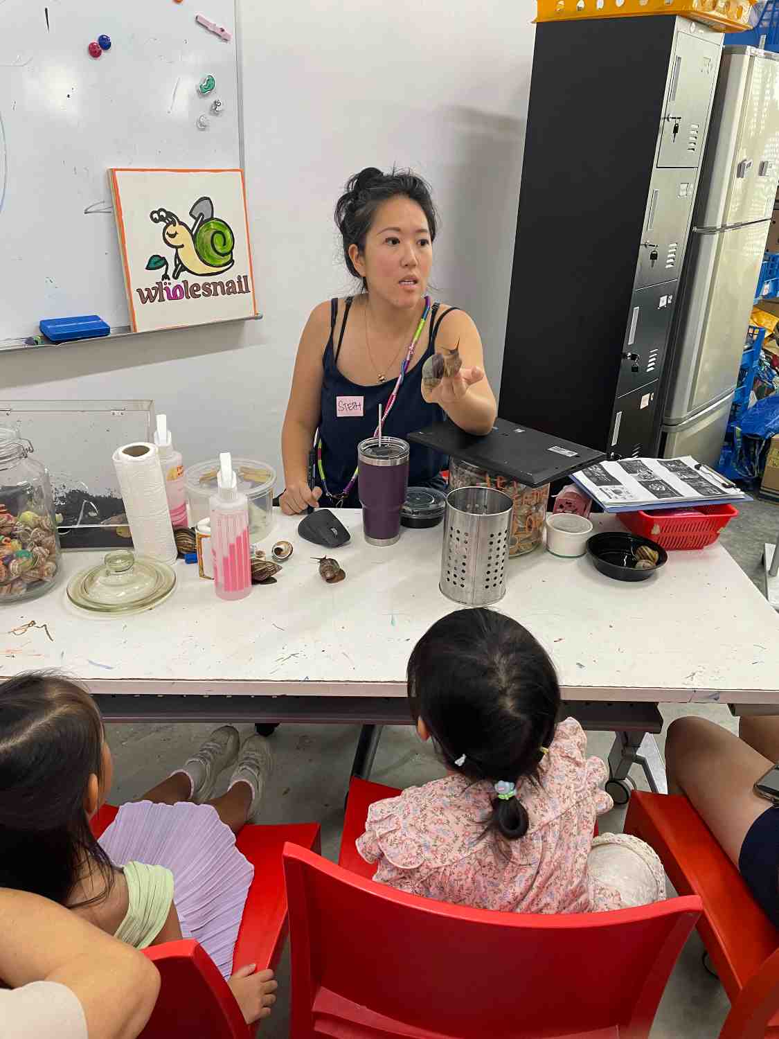 Steph doing a show-and-tell during one of WholeSnail's snail farm tours.