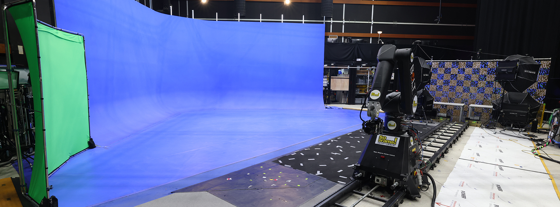 Virtual studio set used for professional film and television production, featuring a robotic camera arm on a rail system.