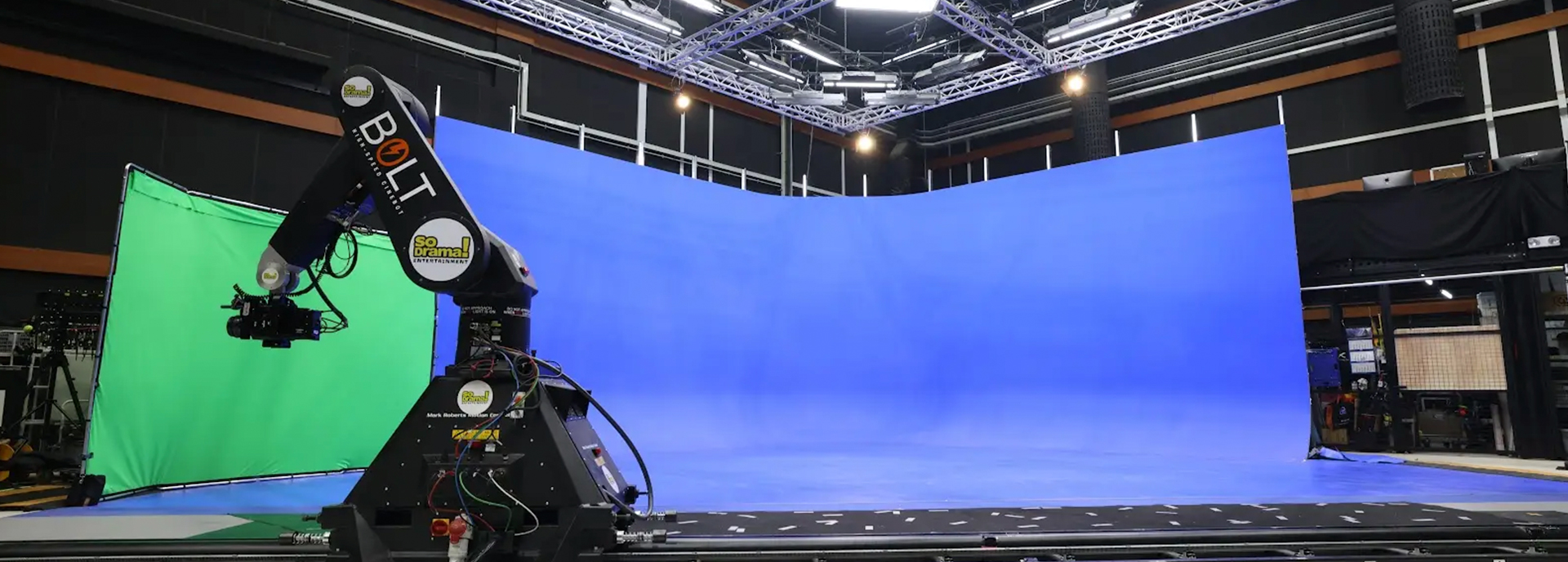 Bolt high-speed camera robot on a studio track in front of green screen and blue cyclorama
