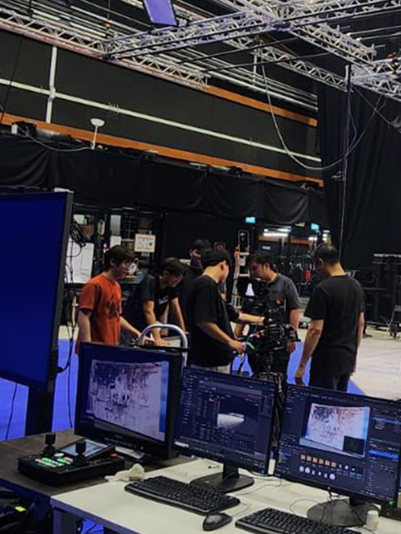 Virtual production studio session, where a film crew is utilizing LED technology for a shoot.